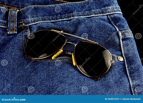 blue jeans and sunglasses on a black background stock image image of backdrop background