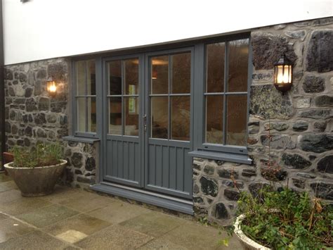 French Doors With Side Windows Installed Into Te Traditional Stone In