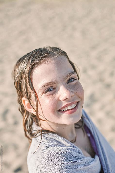 Little Girl With Towel And Wet Hair At The Beach By Stocksy