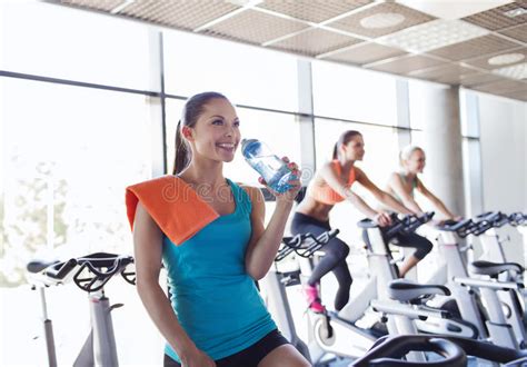 Group Of Women Riding On Exercise Bike In Gym Stock Photo Image 49311480