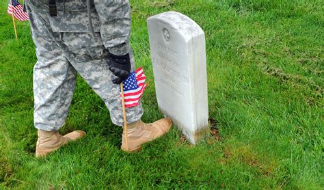 Soldiers Participate During Flags In At Arlington Cemetery Article