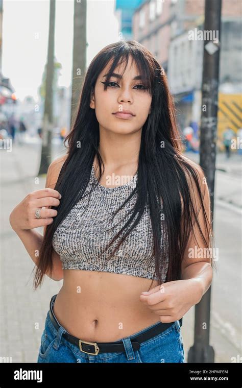 Beautiful Latina Woman With Brown Skin Standing On The Sidewalk Posing