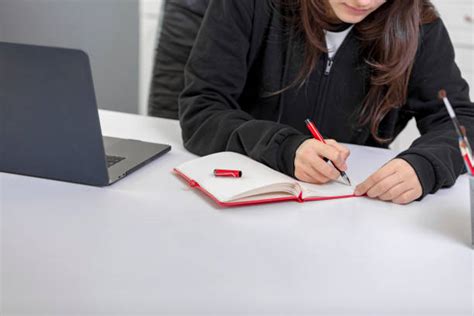 Young Student One Hand Using Laptop One Hand Writing Notes Stock Photos