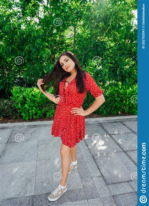 Beautiful Brunette Woman In Red Dress Walks The Streets Of The City Stock Image Image Of Lips