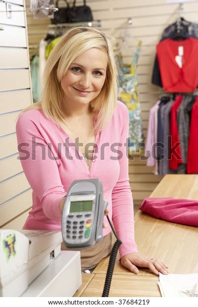 female sales assistant clothing store stock photo edit