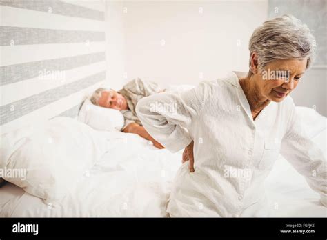 Senior Woman Suffering From Backache Sitting On Bed Stock Photo Alamy