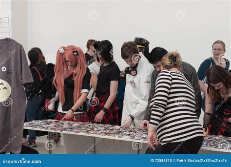 Visitors Of Animefest Showing Anime Buttons At Market Editorial Image