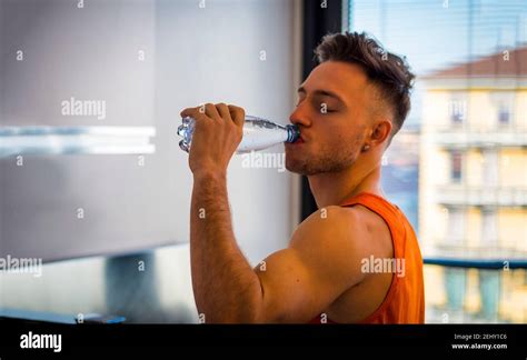 Young Man Drinking Water From Plastic Bottle Stock Photo Alamy