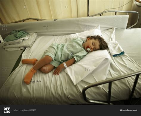 Maybe you would like to learn more about one of these? Sick girl sleeping in a hospital stock photo - OFFSET