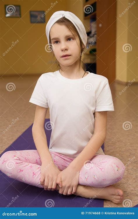 Little Girl Sitting On A Yoga Mat In The Gym Stock Photo Image Of