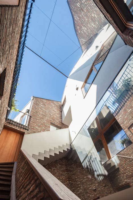 Gewad Apartment Block By Atelier Vens Vanbelle Features Brick Walls And A Mirrored Atrium