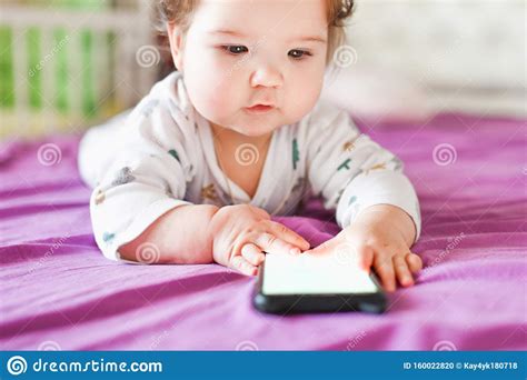 Child Learns By Mobile Phone Little Newborn Baby Reaching For A Mobile