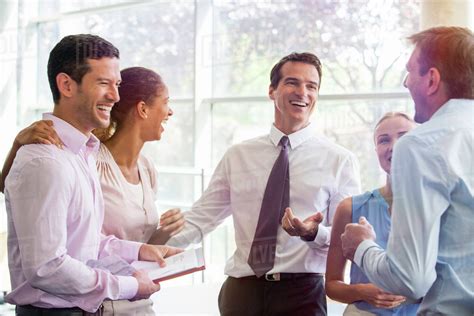 Colleagues Having Laugh Together In Office Stock Photo Dissolve