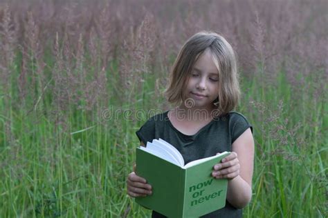 Little Girl Is Reading A Book Outside Stock Image Image Of Reading