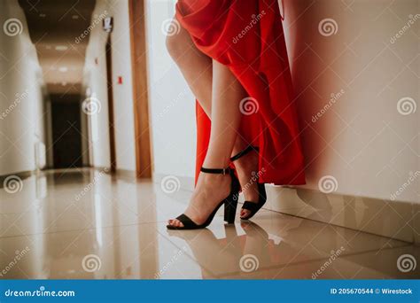 Closeup Shot Of A Woman On A Red Gown Wearing A Beautiful Ankle Strap
