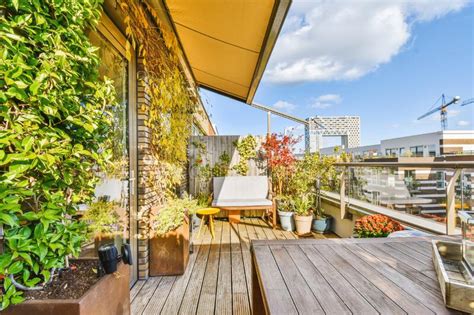 A Balcony With Wooden Floors And Plants And A Table Stock Photo Image