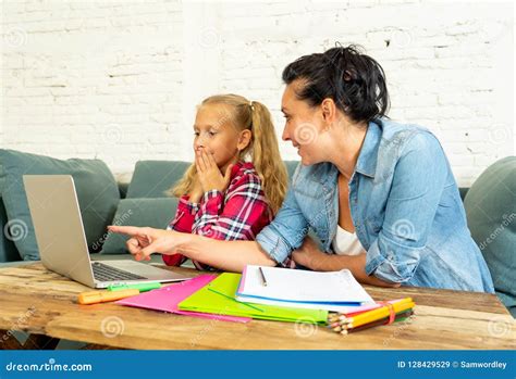 Single Mum Helping Her Daughter Doing Her Homework With Laptop At Home Stock Image Image Of