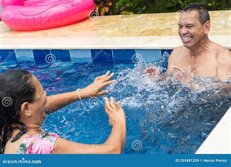 Couple Having Fun In A Swimming Pool On Vacation Stock Image Image Of Smiling Active 253481209