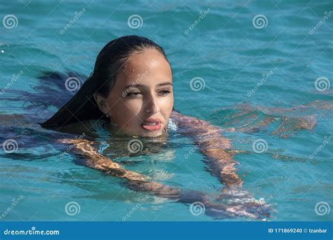 Black Hair Mexican Latina Girl Swimming In Crystal Sea Waters Stock