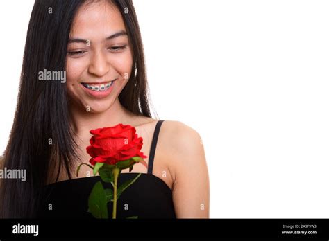 Young Happy Asian Teenage Girl Smiling While Holding Red Rose Stock