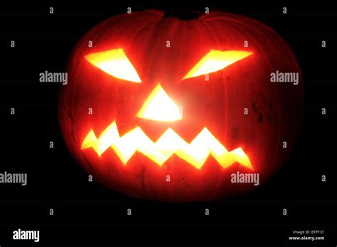 Scary Halloween Pumpkin Face Glowing In The Dark Stock Photo Alamy