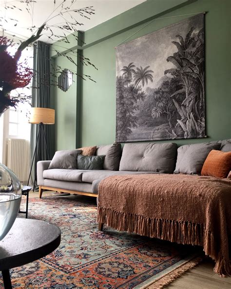 Gray Tapestry Over A Gray Sofa Green Walls And A Beautiful Green And Clay