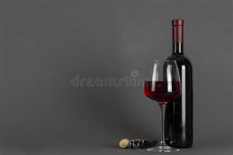 Red Wine Bottle Without Label Corkscrew And Empty Glass On Purple