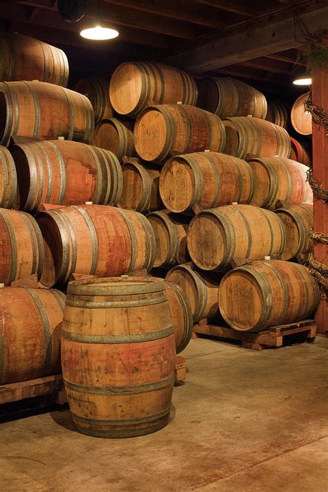 Old Wine Barrels Stacked In Winery Photograph By Yinyang