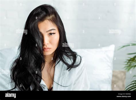 Attractive Brunette Thai Woman Looking At Camera In Bedroom Stock Photo Alamy