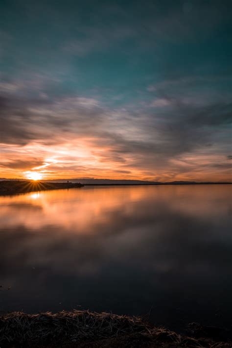 Download 1440x3168 Sunset Reflection Clouds Sky Lake Wallpapers For