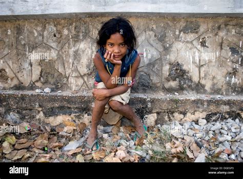 A Young Girl Living In Poverty Is Relaxing On A Buddhist Stupa In