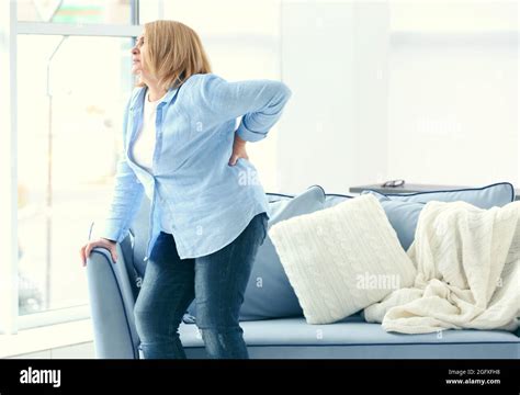 Senior Woman Suffering From Backache At Home Stock Photo Alamy