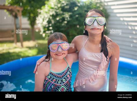 Tween Girls 10 12 Wearing Swimming Goggles With Arms Around Each Other