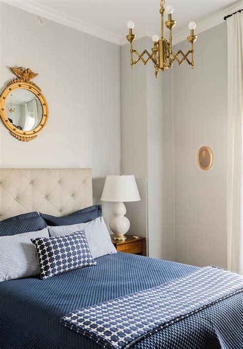 Gray And Gold Bedroom With Gold Mirror Over Headboard Transitional