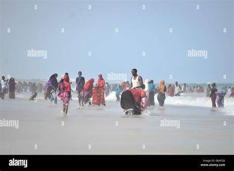 People Play In The Ocean On Lido Beach In Mogadishu Somalia During