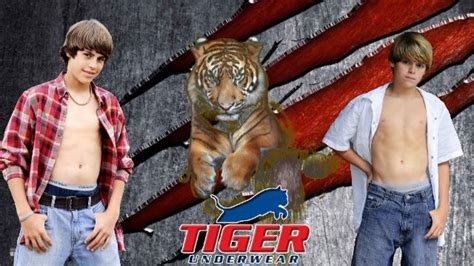 Two Young Men Standing Next To Each Other In Front Of A Tiger Wallpaper
