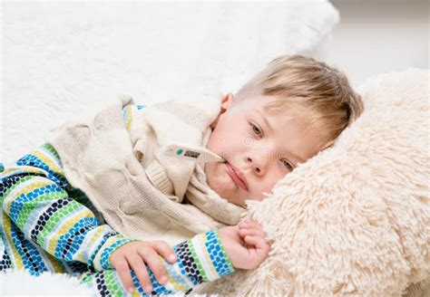 Sad Sick Boy With Thermometer Laying In Bed Stock Photo Image Of Face