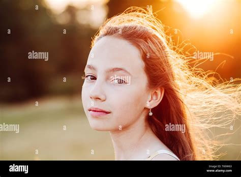 Portrait Of Beautiful Serious Teen Girl Is Enjoying Nature In The Park