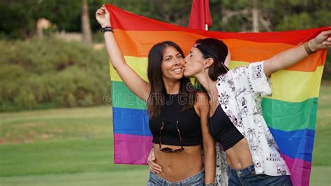 Spanish Lesbian Couple Posing In A Golf Field With A Pride Flag Stock Image Image Of Adult