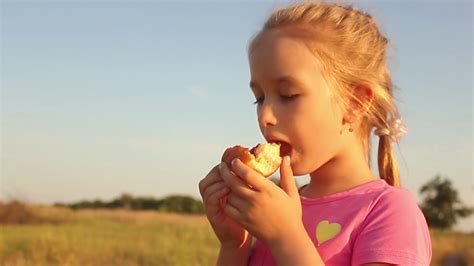 Cute Kid Girl Eating Sweet Donut Outdoor In Stock Footage Sbv 316282655