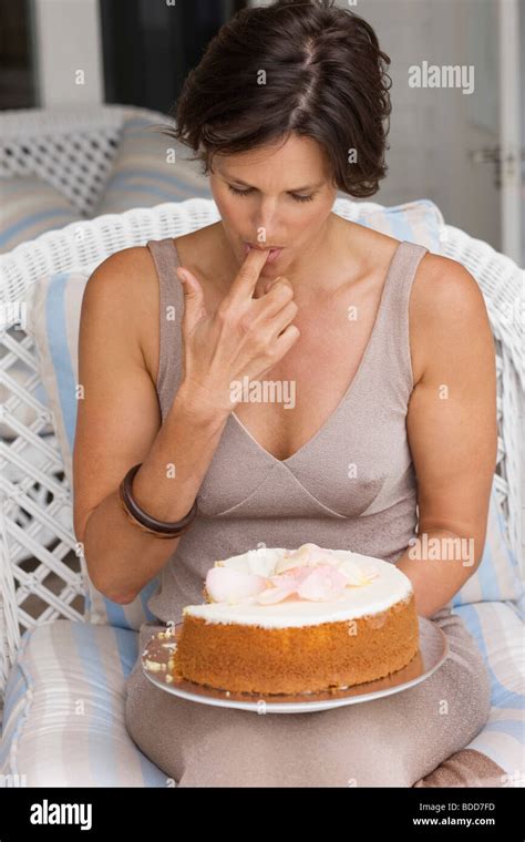 Woman Tasting A Cake Stock Photo Alamy