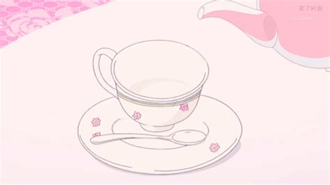 A Tea Cup And Saucer Sitting On Top Of A White Plate With Pink Flowers