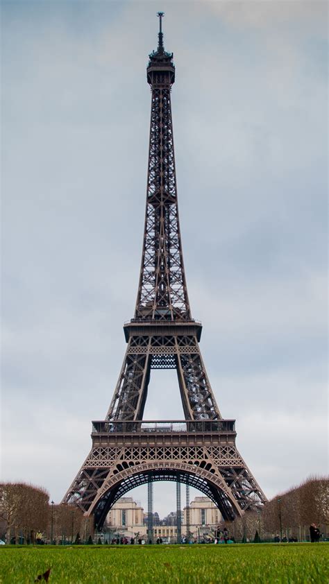 Straight Picture Of Paris Eiffel Tower With Grass Field In Front And