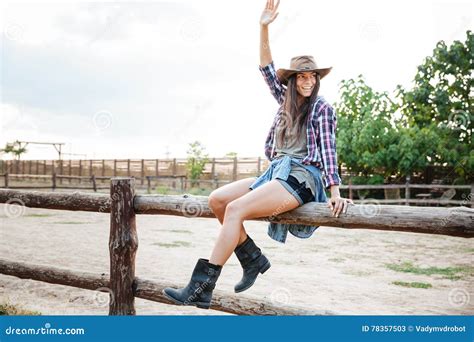 Cheerful Woman Cowgirl Sitting On Fence And Having Fun Stock Image