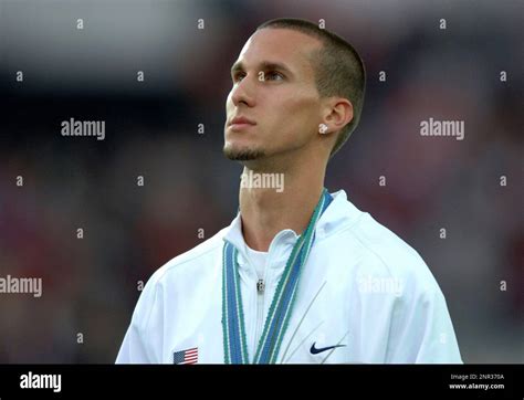 Gold Medalist Jeremy Wariner Of The United States Listens To National