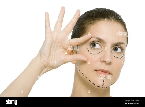Woman With Plastic Surgery Markings On Face Touching Face Looking