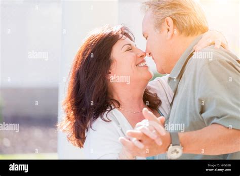 Happy Middle Aged Couple Enjoy A Romantic Slow Dance Outside Stock Photo Alamy
