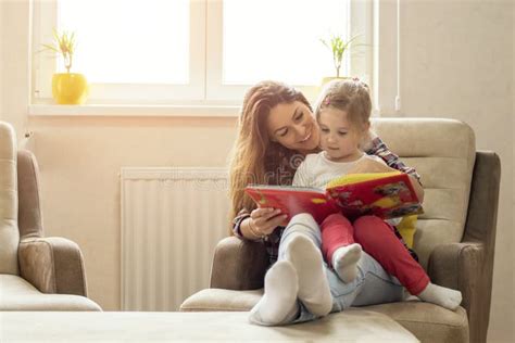 Caucasian Mother Reading A Fairy Tale For Her Child At Home Stock Image