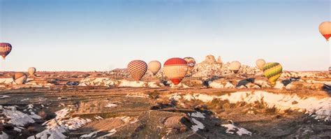 Panorama Of Hot Air Balloons In The Sky During Sunrise Flying Over