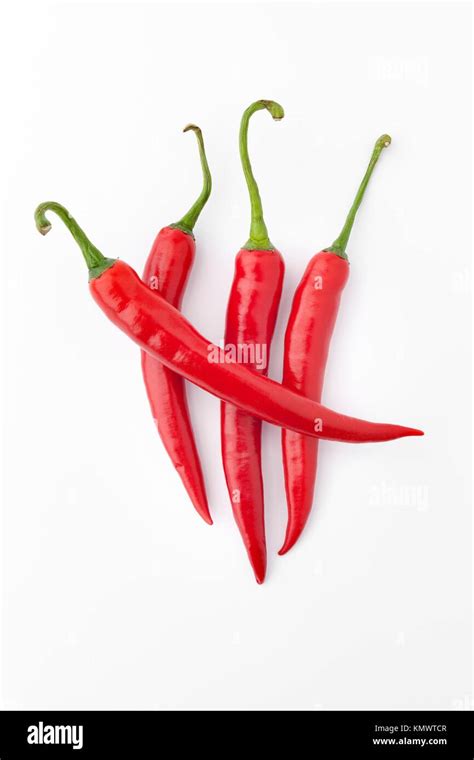 Four Red Hot Peppers On White Background Stock Photo Alamy